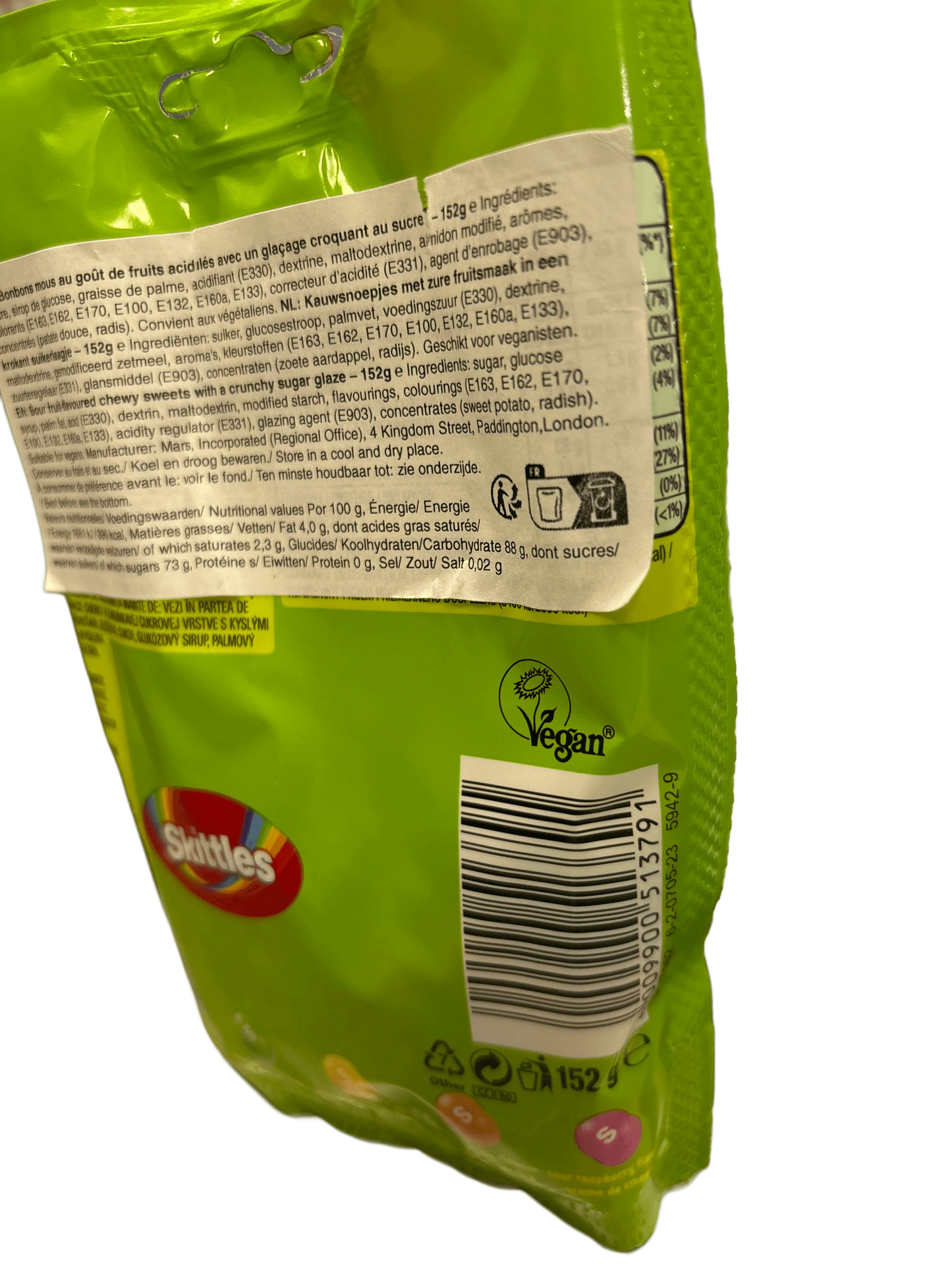 Back of Skittles green candy bag with ingredients, nutrition facts, barcode, and vegan label