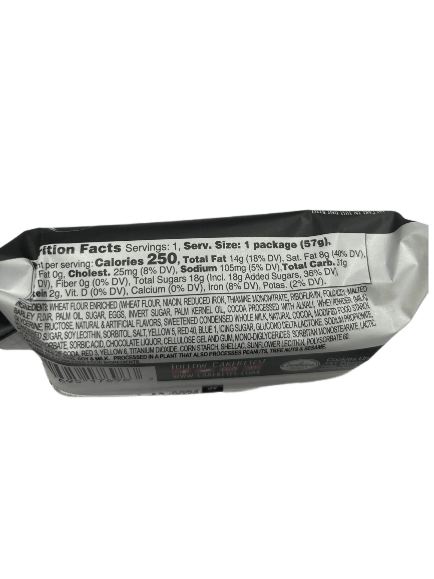 Close-up of snack packaging nutrition facts and ingredients label, black background