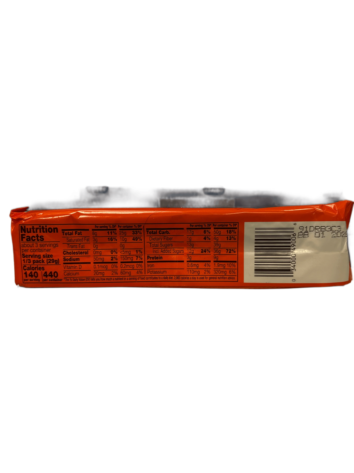 Back of exotic snack package showing nutrition facts and barcode, orange background