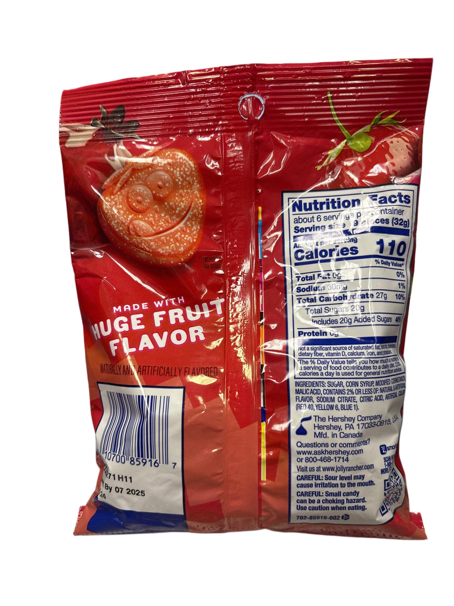 Back of a red candy package with fruit graphics, nutrition facts, and barcode visible