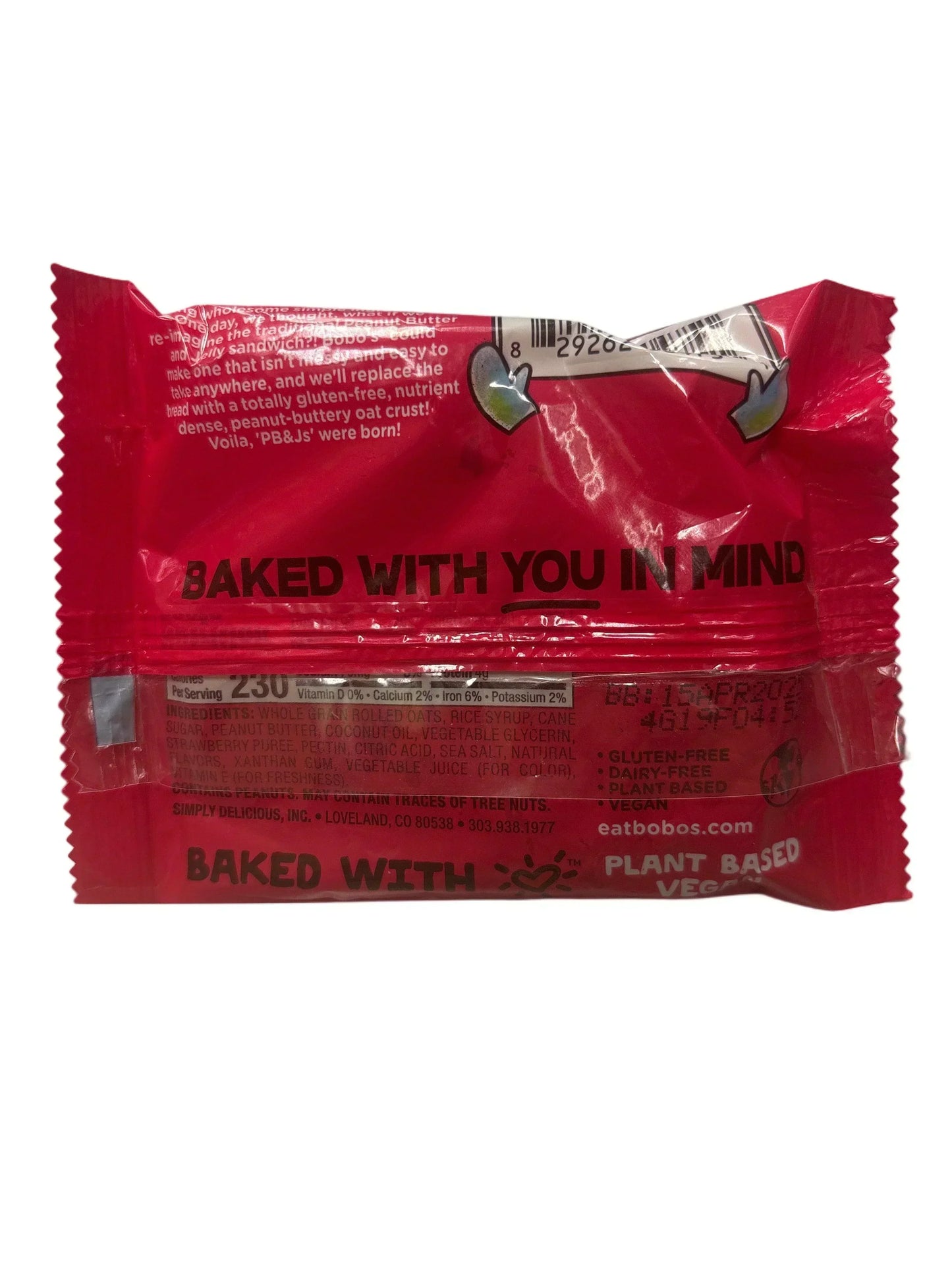 Back of a bright red vegan snack bar wrapper showing nutrition info and plant-based label