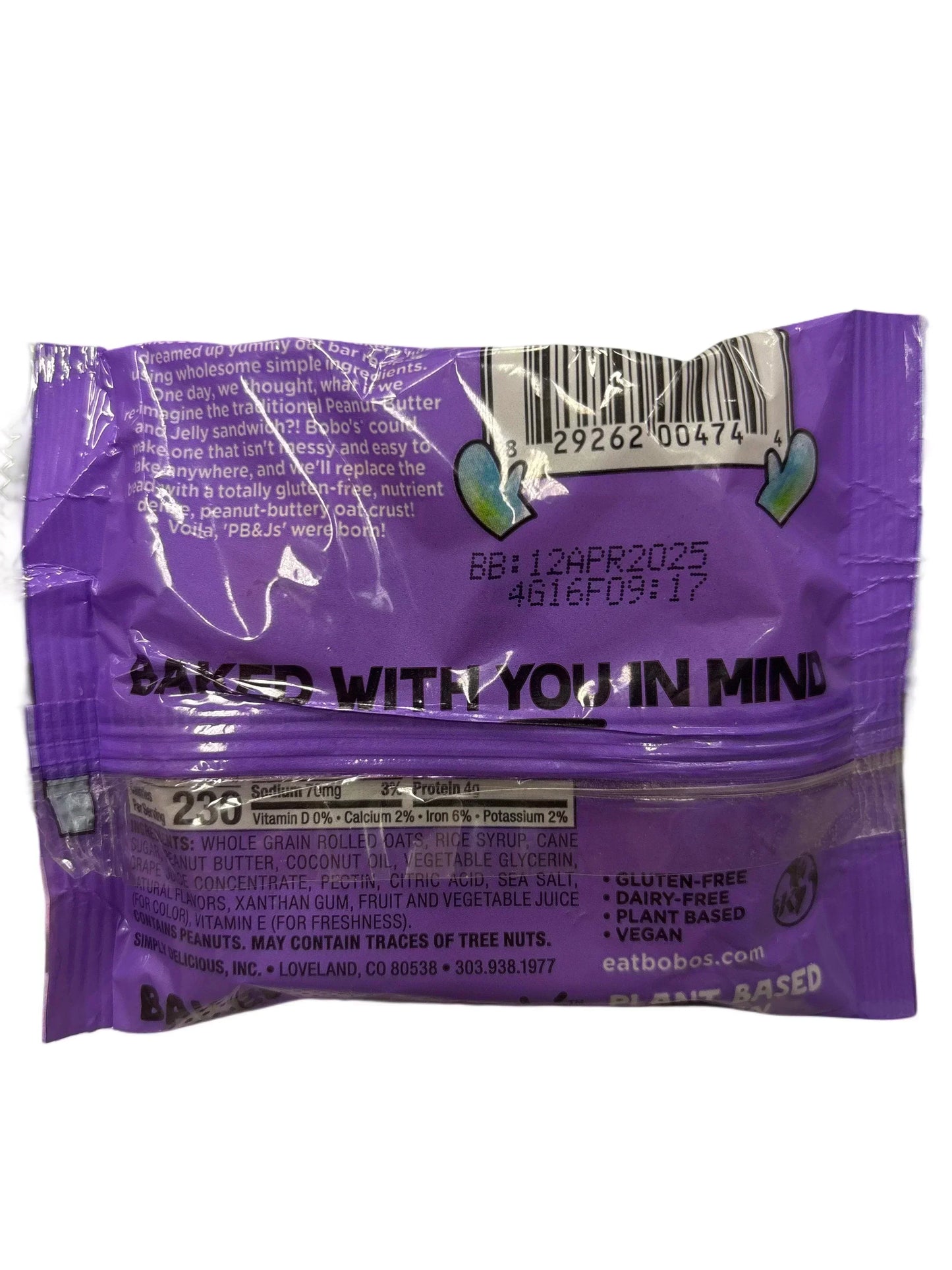 Back of purple packaged oat snack bar showing ingredients, gluten-free, vegan labels.