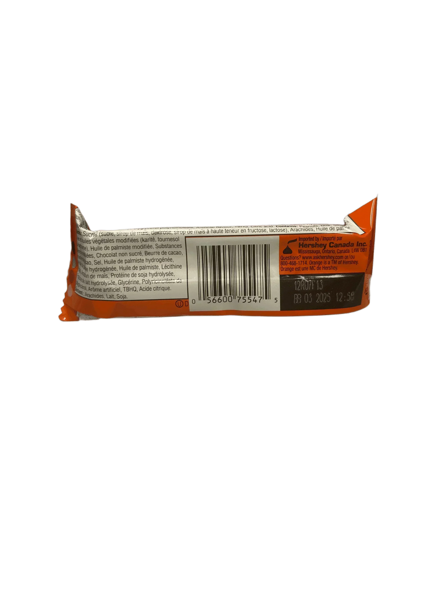 Back of an imported candy bar with barcode, ingredients text, and orange packaging.